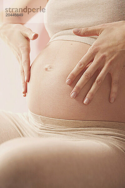 Feathering Therapeutic Massage  Pregnant Woman Massaging her Stomach