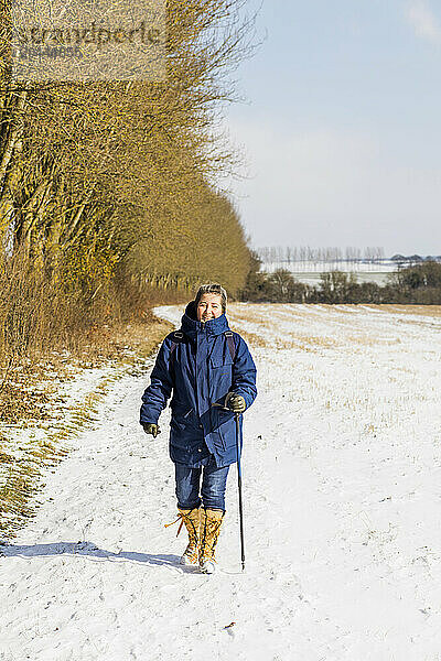 Woman Hiking on Snow covered Field