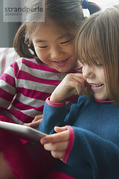 Young Girls Using Digital Tablet Smiling