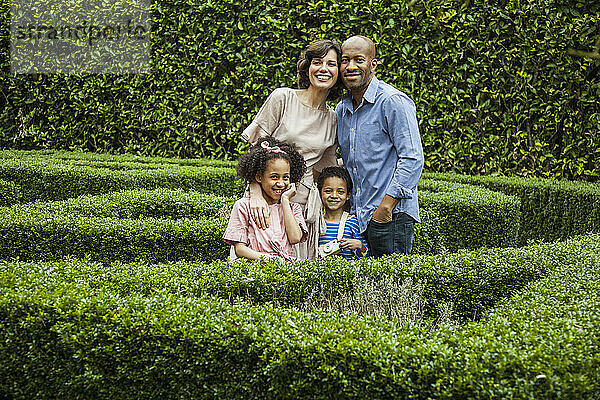 Portrait of Family in Garden Smiling