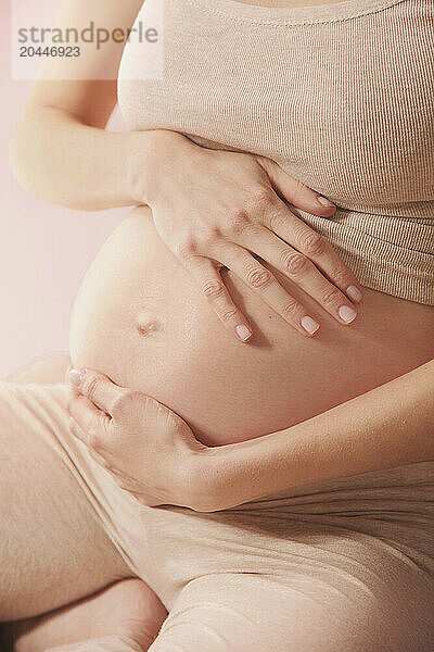 Therapeutic Massage  Pregnant Woman Massaging her Stomach