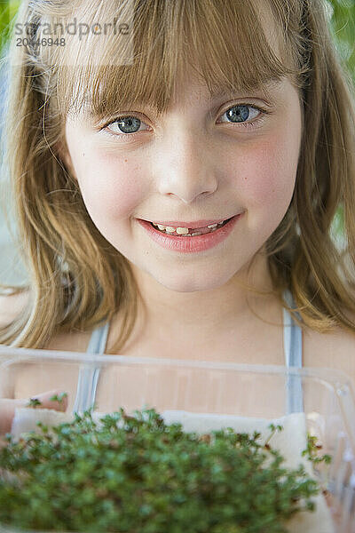 Young Girl Holding Watercress Seedlings