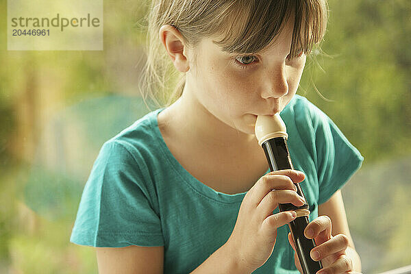 Young Girl Playing Recorder