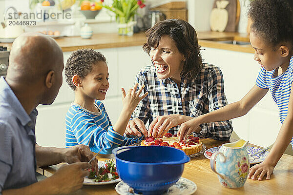 Happy Family around Kitchen Table