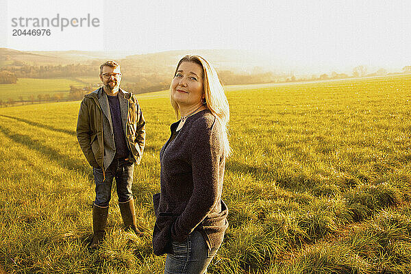 Man and Woman Standing in a Field