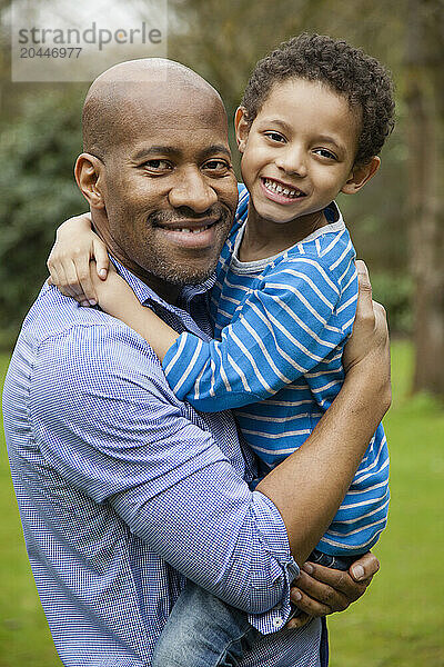 Father and Young Son Hugging Outdoors