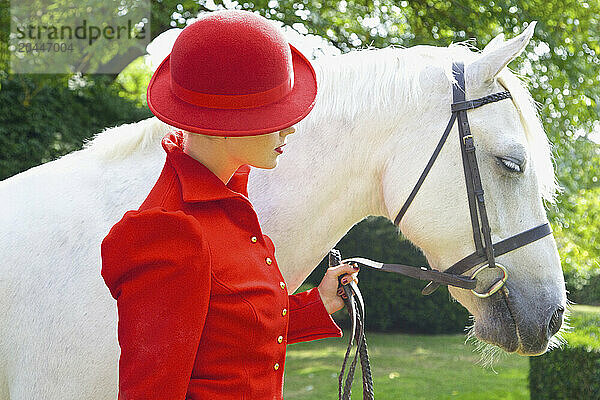 Woman in Red Equestrian Outfit with Horse