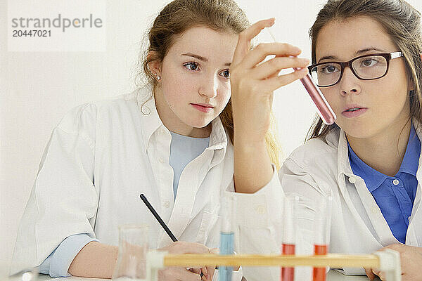 Schoolgirls at Chemistry Class Holding Test Tube