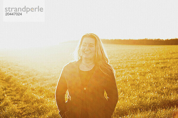 Woman Standing in a Field Smiling