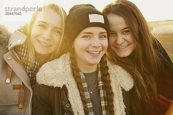 Portrait of Three Teenage Girls Smiling