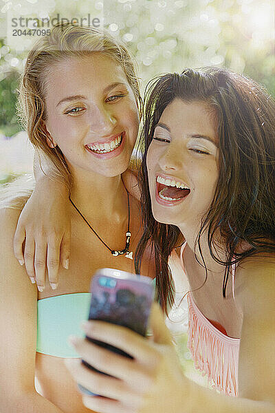 Two Young Women Taking Selfie Laughing