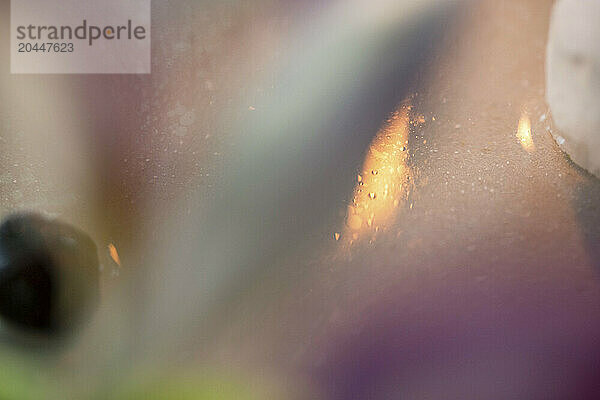 This is a close-up  abstract image focusing on texture  light  and color  with a dreamy or blurred effect.