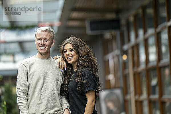 Smiling couple posing together at a cozy outdoor venue