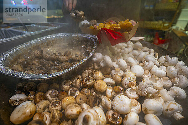 Hot mushrooms on Christmas Market stall in Old Market Square at dusk  Nottingham  Nottinghamshire  England  United Kingdom  Europe