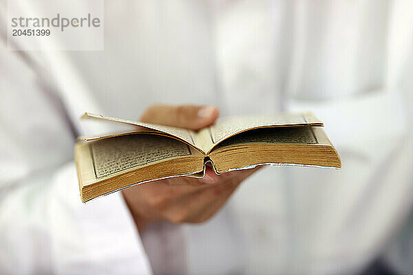 Muslim man reading an Arabic Holy Quran (Koran)  Jamiul Azhar Mosque  Vietnam  Indochina  Southeast Asia  Asia