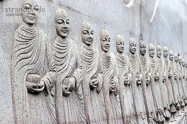 Carved relief showing Buddhist monks (Sangha) with alms bowls  Phap Vien Minh Dang Quang pagoda  Ho Chi Minh City  Vietnam  Indochina  Southeast Asia  Asia