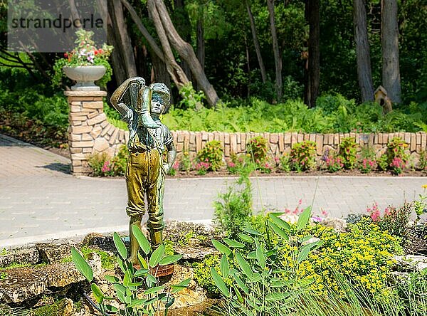 Boy with the Boot statue and fountain  Assiniboine Park  Winnipeg  Manitoba  Canada. It was originally displayed in 1898 in front of the old Winnipeg City Hall and may have been cast in Italy.