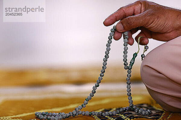 Close-up of hand of Muslim man praying with Islamic prayer beads  Chau Doc  Vietnam  Indochina  Southeast Asia  Asia