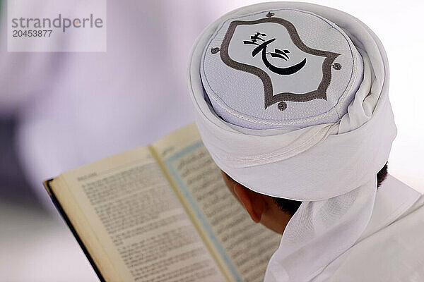 Muslim man reading an Arabic Holy Quran (Koran)  Jamiul Azhar mosque  Vietnam  Indochina  Southeast Asia  Asia