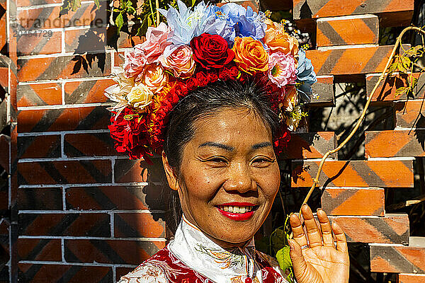 Traditionally dressed woman with a flower bouquet in her hair  Quanzhou  Fujian  China  Asia