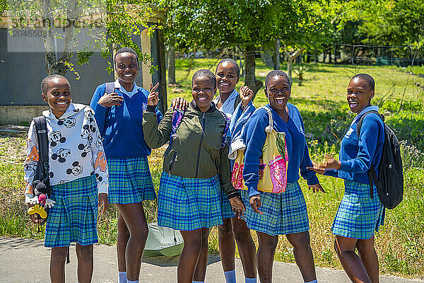 View of school girls smiling for camera in traditional Zulu village  Veyane Cultural Village  Khula  Khula Village  KwaZulu-Natal Province  South Africa  Africa