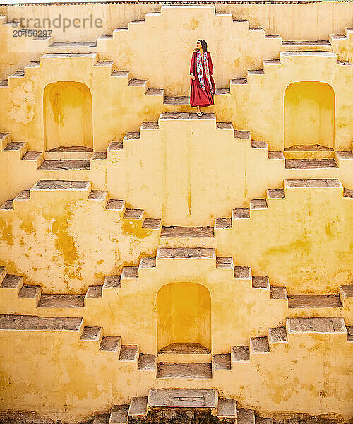 Woman in red garment at Panna Meena ka Kund  Jaipur  Rajasthan  India  Asia