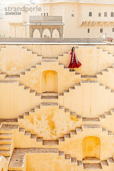 Woman in red garment at Panna Meena ka Kund  Jaipur  Rajasthan  India  Asia