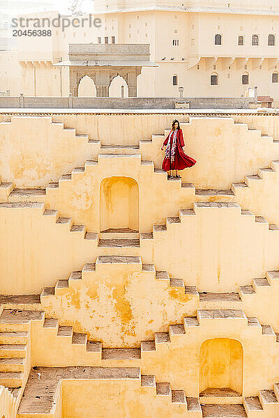 Woman in red garment at Panna Meena ka Kund  Jaipur  Rajasthan  India  Asia