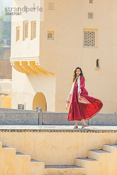 Woman in red garment at Panna Meena ka Kund  Jaipur  Rajasthan  India  Asia