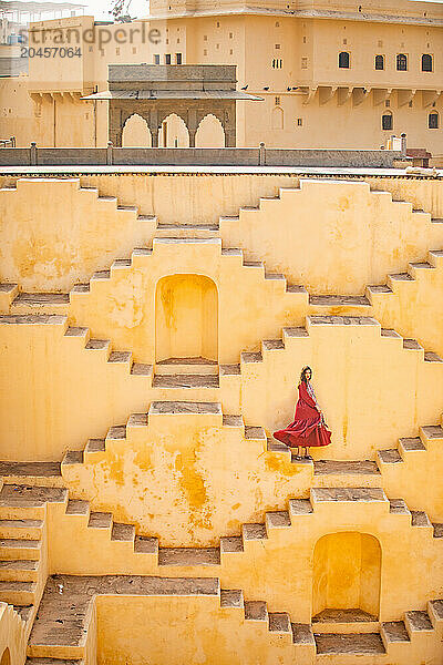 Woman in red garment at Panna Meena ka Kund  Jaipur  Rajasthan  India  Asia