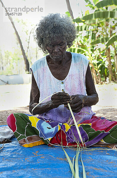 A woman  Aboriginal elder  weaving baskets  Nyinyikay Homeland  East Arnhem Land  Northern Territory  Australia  Pacific