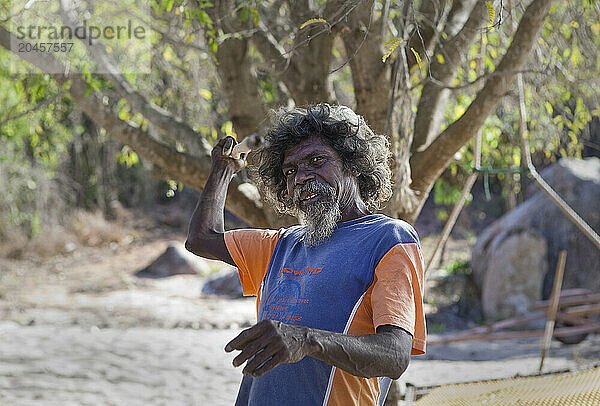 Portrait  Yolngu man  showing spear fishing action at Bawaka Homeland  East Arnhem Land  Northern Territory  Australia  Pacific