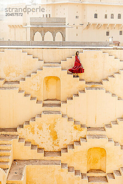 Woman in red garment at Panna Meena ka Kund  Jaipur  Rajasthan  India  Asia