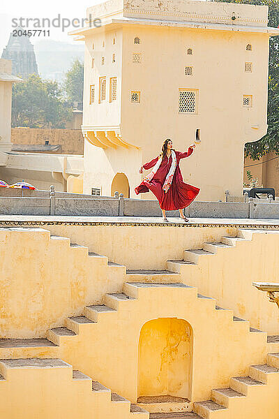 Woman in red garment at Panna Meena ka Kund  Jaipur  Rajasthan  India  Asia