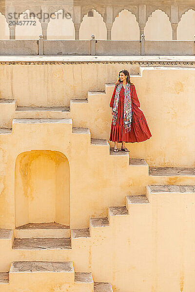 Woman in red garment at Panna Meena ka Kund  Jaipur  Rajasthan  India  Asia