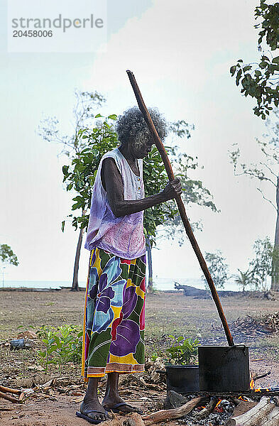 A woman  Aboriginal elder  stirring pandanus for weaving baskets  Nyinyikay Homeland  East Arnhem Land  Northern Territory  Australia  Pacific