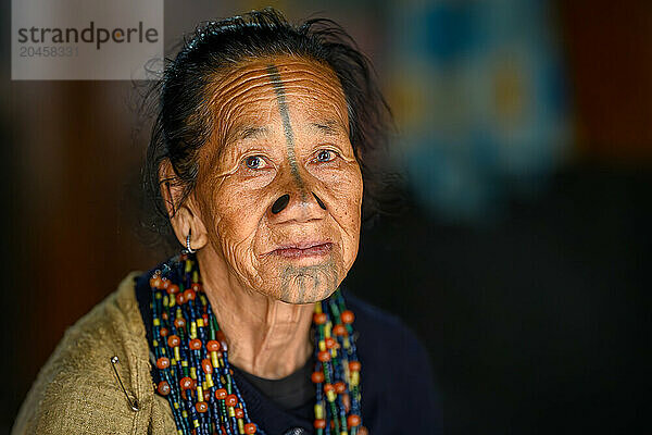 Portrait of a woman with nose plugs and facial tattoo  Apatani Tribe  Ziro Valley  Arunachal Pradesh  India  Asia