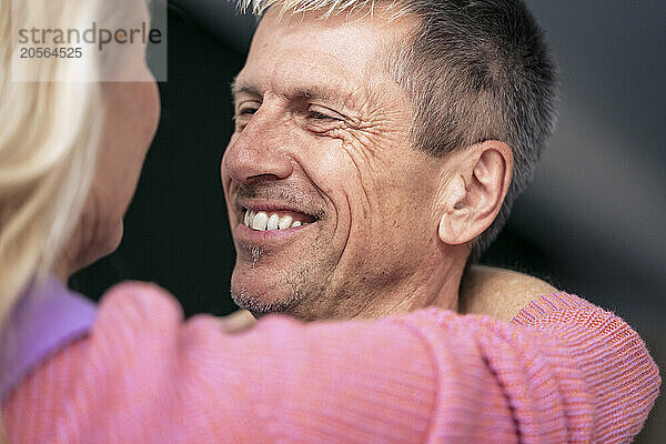 Happy retired senior man looking at woman