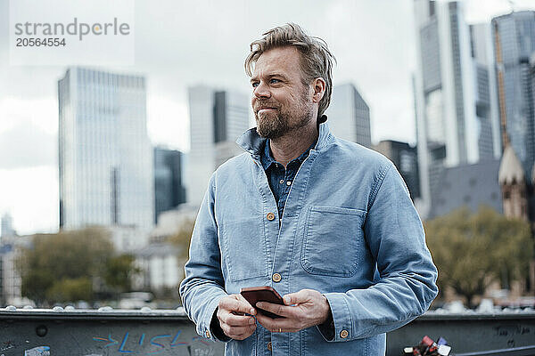 Smiling Businessman with mobile phone