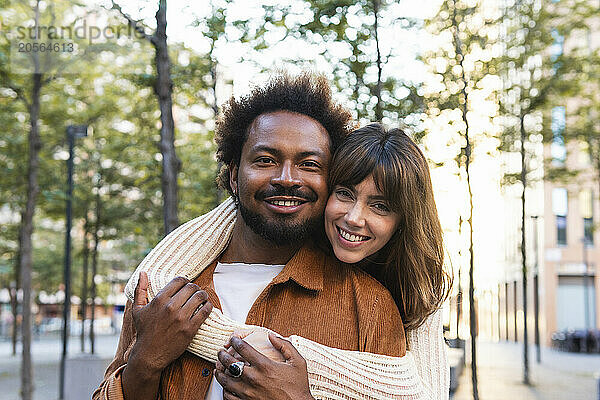 Happy woman with hugging boyfriend from behind