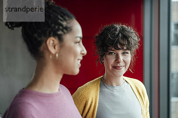 Smiling entrepreneur with colleague in office