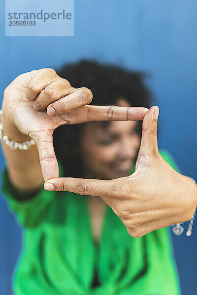 Woman making finger frame with hands