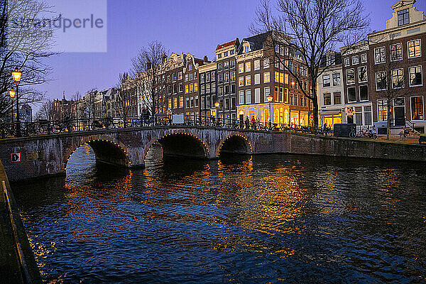 Residential buildings near canals at sunset in Netherlands