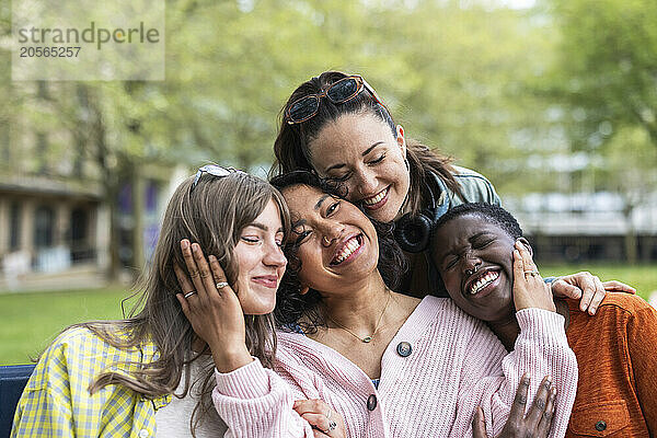 Smiling female friends embracing each other