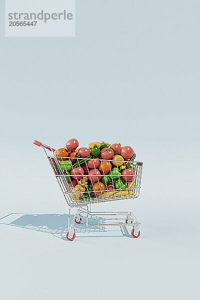 Shopping cart with colorful fruits and vegetables against blue background