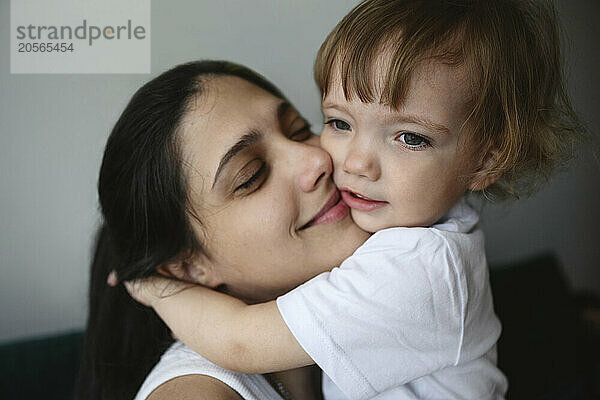 Smiling mother with baby boy at home