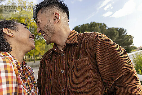 Cheerful man enjoying leisure time with girlfriend at park