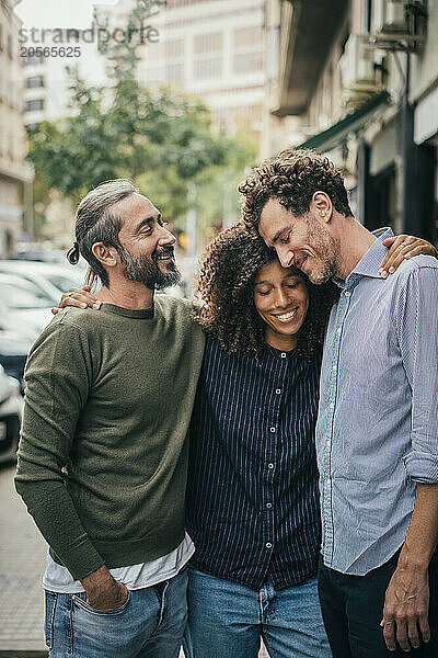 Business friends huddling each other at street