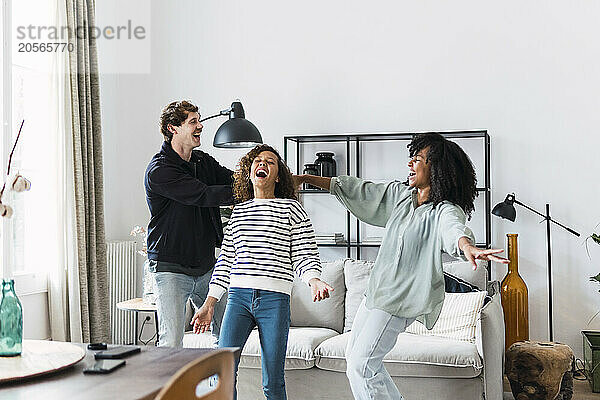 Happy family havin fun dancing together in the living room