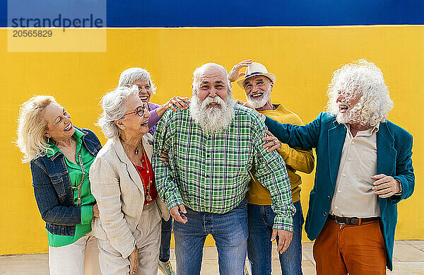 Cheerful senior men and women catching friend